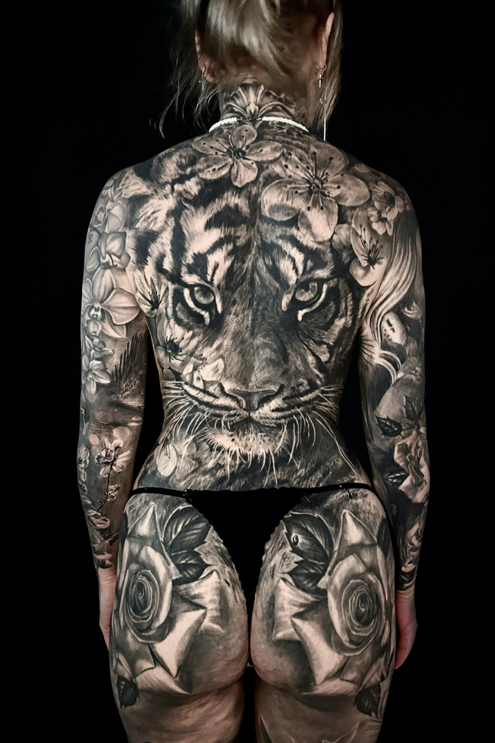 A full female tiger backpiece tattoo